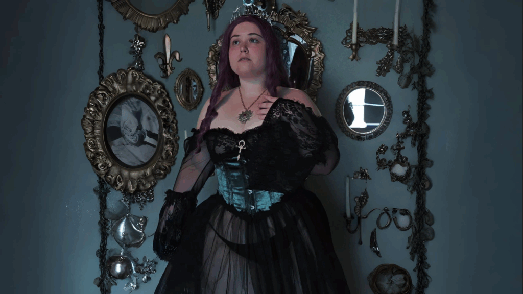 Woman in gothic steampunk corset dress standing in a vintage mirror-filled room
